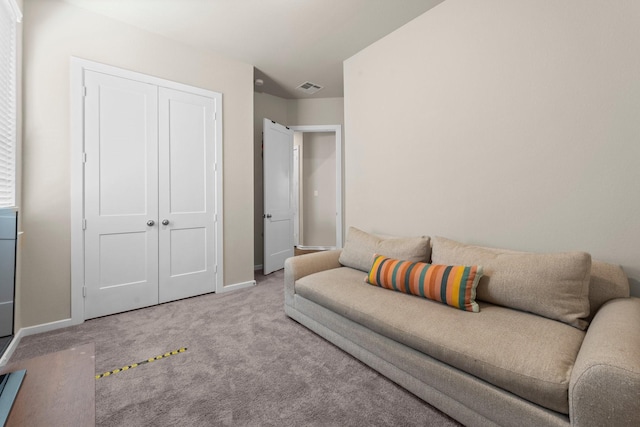 living room with visible vents, baseboards, and carpet