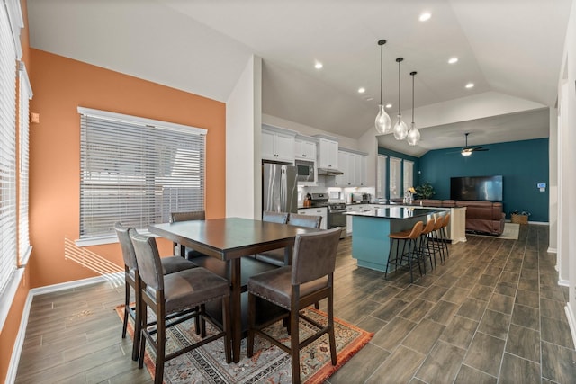 dining space featuring ceiling fan, baseboards, wood finish floors, vaulted ceiling, and recessed lighting