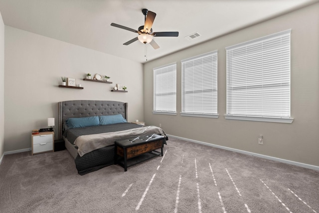 carpeted bedroom featuring a ceiling fan, baseboards, and visible vents