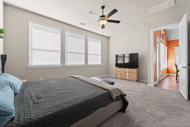 bedroom with visible vents, baseboards, carpet, and ceiling fan