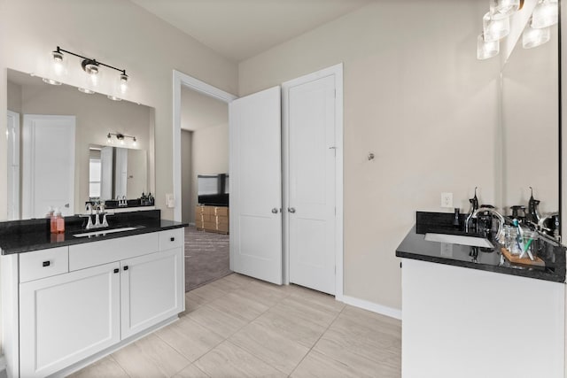 bathroom with baseboards and vanity