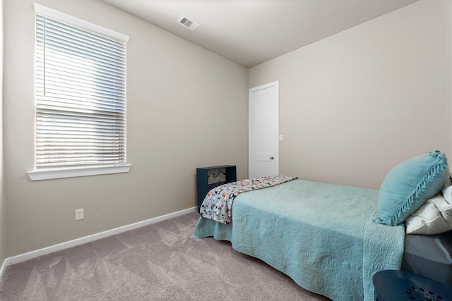 bedroom with baseboards, visible vents, and carpet floors