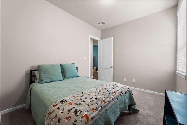 carpeted bedroom with visible vents and baseboards