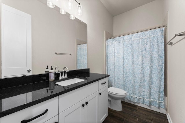 full bath featuring wood finish floors, toilet, shower / bath combo, and vanity