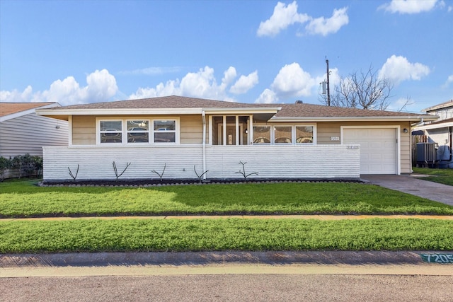 single story home with a front yard, a garage, and driveway