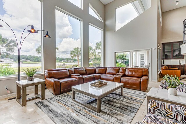 18752 Palm Beach Blvd, Montgomery, TX 77356 - living area featuring a towering ceiling, baseboards, and light tile patterned floors