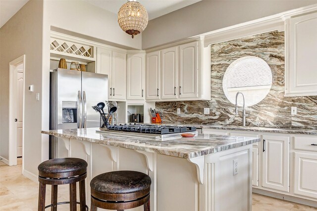 18752 Palm Beach Blvd, Montgomery, TX 77356 - kitchen with a kitchen island, tasteful backsplash, light stone counters, and white cabinetry