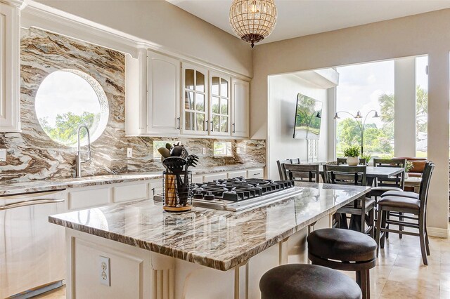18752 Palm Beach Blvd, Montgomery, TX 77356 - kitchen with dishwasher, tasteful backsplash, light stone countertops, a sink, and a kitchen island