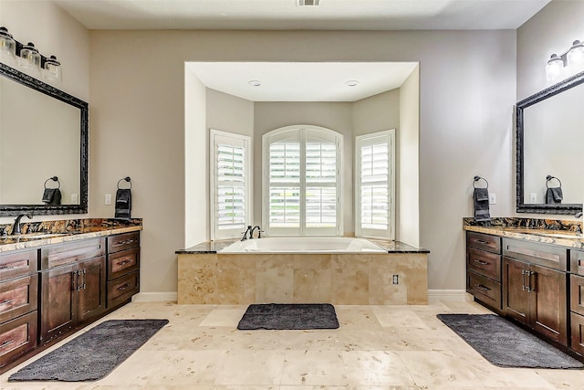18752 Palm Beach Blvd, Montgomery, TX 77356 - full bathroom featuring a bath, two vanities, and baseboards