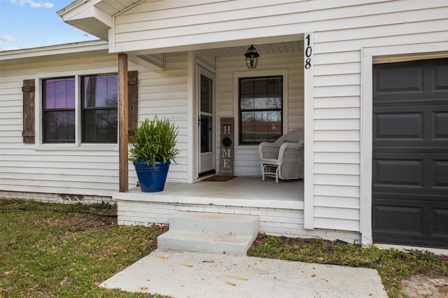 property entrance featuring a porch and a garage