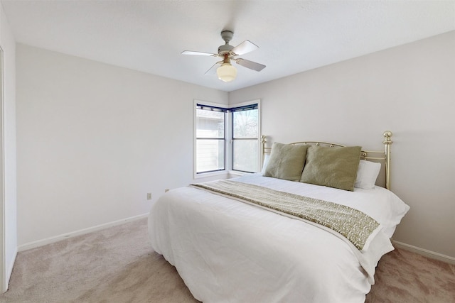 bedroom featuring baseboards, light carpet, and ceiling fan