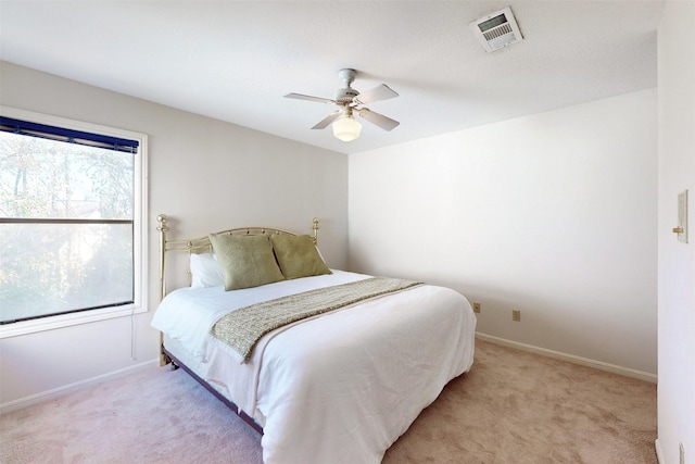 bedroom featuring visible vents, carpet floors, baseboards, and a ceiling fan