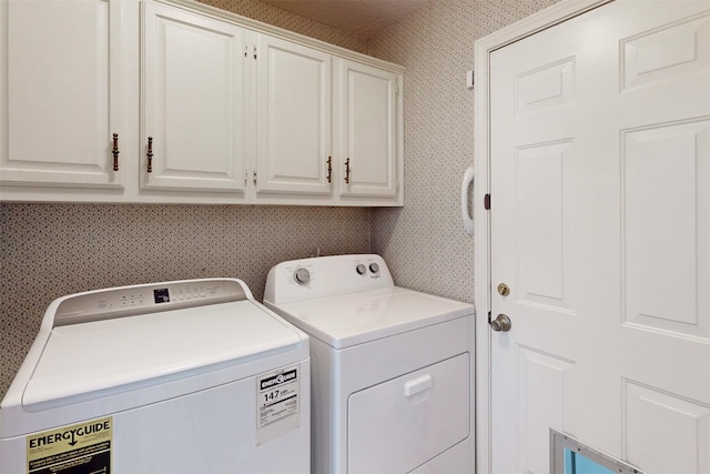 laundry room with wallpapered walls, cabinet space, and independent washer and dryer