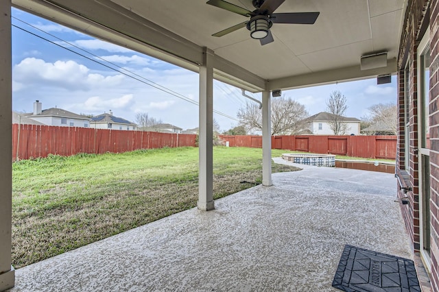 view of patio with a fenced backyard and a ceiling fan