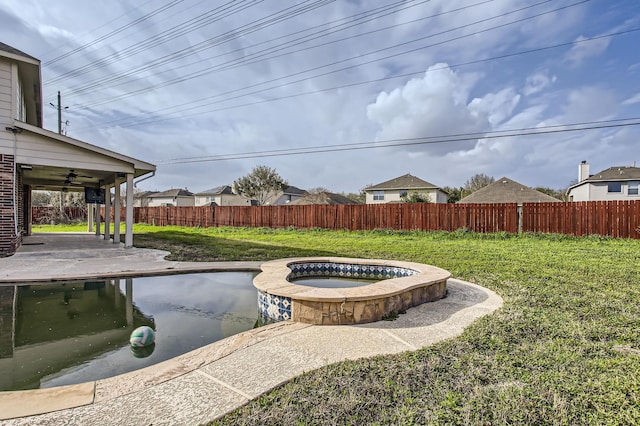 view of yard featuring a patio, a fenced backyard, a ceiling fan, and a pool with connected hot tub