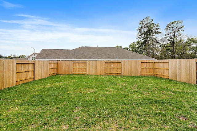 view of yard with a fenced backyard