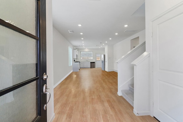 entryway featuring light wood finished floors, visible vents, recessed lighting, and stairs