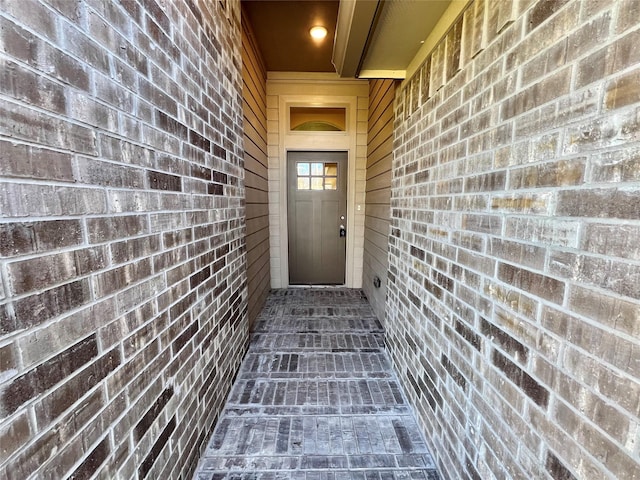 property entrance with brick siding