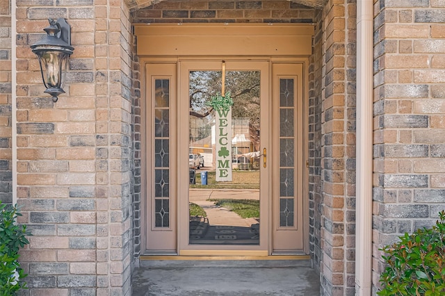 entrance to property with brick siding