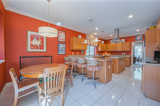 kitchen with a peninsula, crown molding, a wealth of natural light, and island range hood