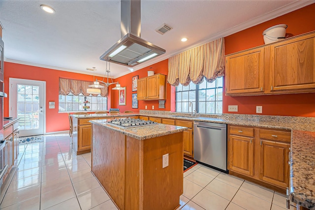 kitchen featuring visible vents, a sink, stainless steel appliances, brown cabinetry, and island range hood