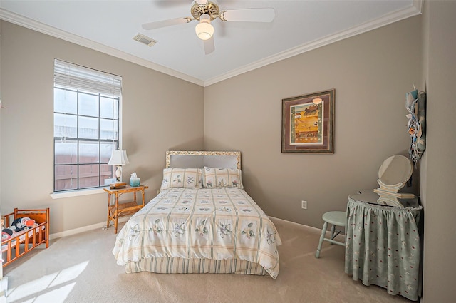 carpeted bedroom featuring ceiling fan, visible vents, baseboards, and ornamental molding