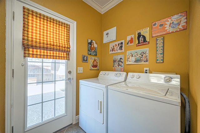 clothes washing area with washer and dryer, laundry area, and ornamental molding