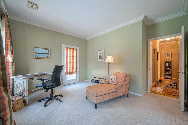 carpeted office with visible vents, attic access, baseboards, and ornamental molding