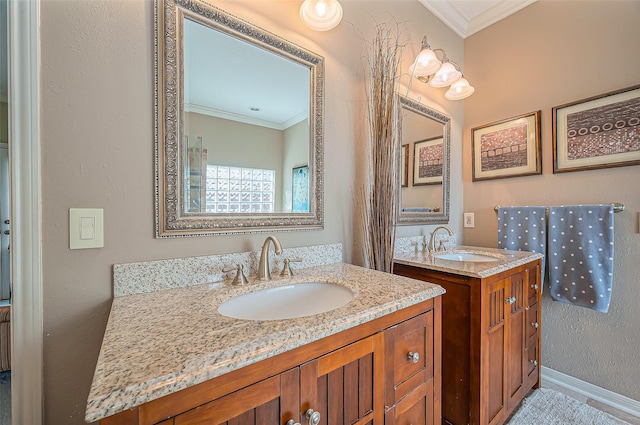 bathroom featuring ornamental molding, two vanities, and a sink