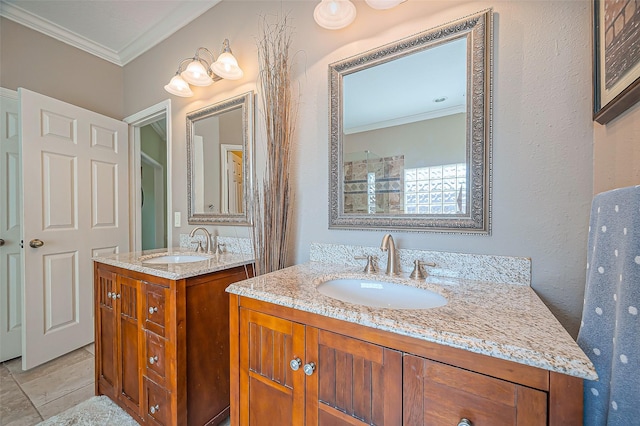 full bath with two vanities, ornamental molding, and a sink