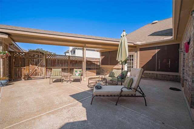 view of patio / terrace with outdoor lounge area, a gate, and fence