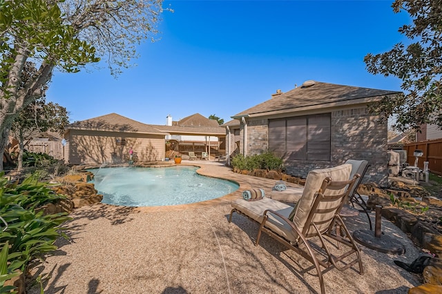 outdoor pool featuring a patio area and fence