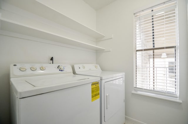 laundry area featuring laundry area, baseboards, and washing machine and clothes dryer