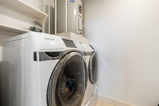 washroom featuring laundry area, independent washer and dryer, and baseboards