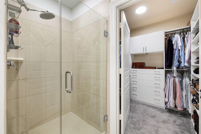 full bathroom with a stall shower and a spacious closet