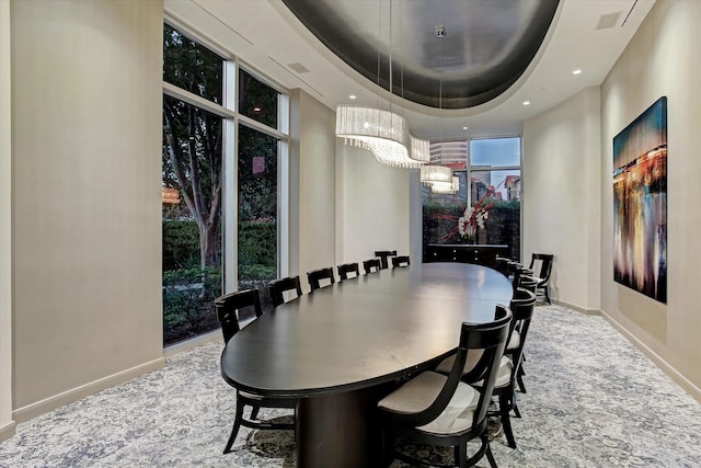 carpeted dining room featuring visible vents, baseboards, a tray ceiling, recessed lighting, and an inviting chandelier