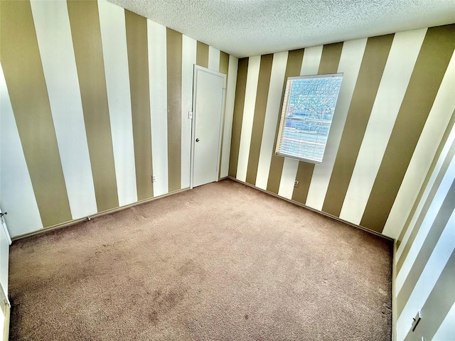 unfurnished bedroom featuring wallpapered walls, carpet, and a textured ceiling