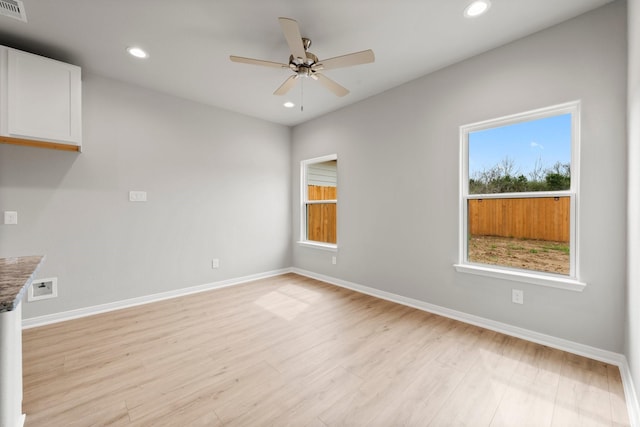 spare room featuring recessed lighting, baseboards, light wood-style floors, and a ceiling fan