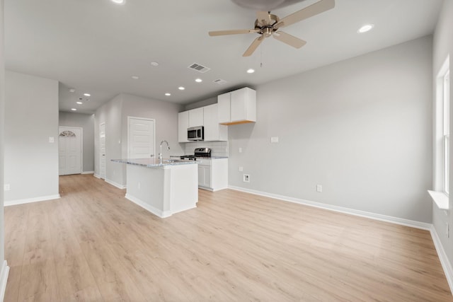 kitchen featuring visible vents, baseboards, appliances with stainless steel finishes, light wood-style floors, and white cabinets