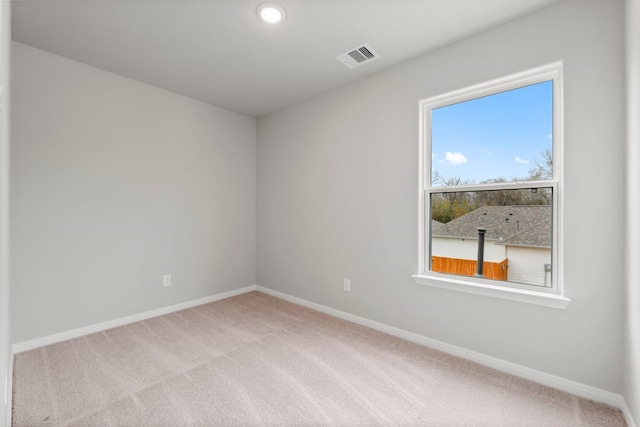 unfurnished room featuring visible vents, baseboards, and carpet flooring