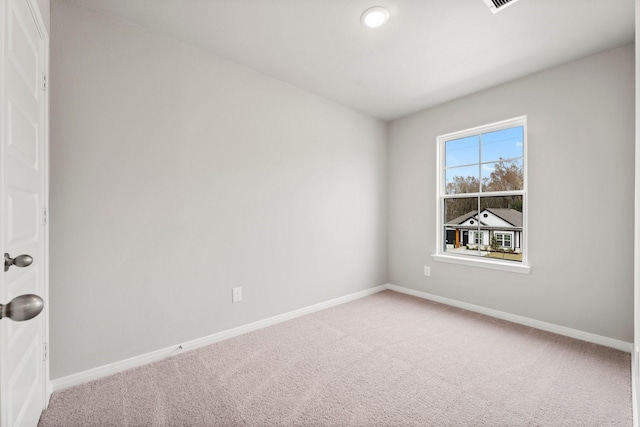 empty room with carpet and baseboards