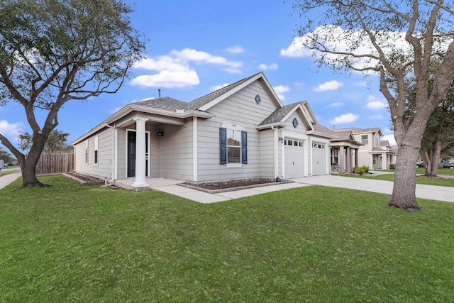 view of front of home featuring concrete driveway, an attached garage, fence, and a front lawn