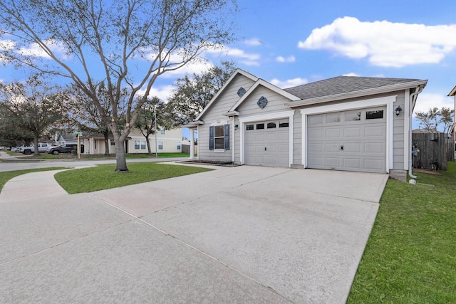 ranch-style house featuring a front yard, driveway, and a shingled roof