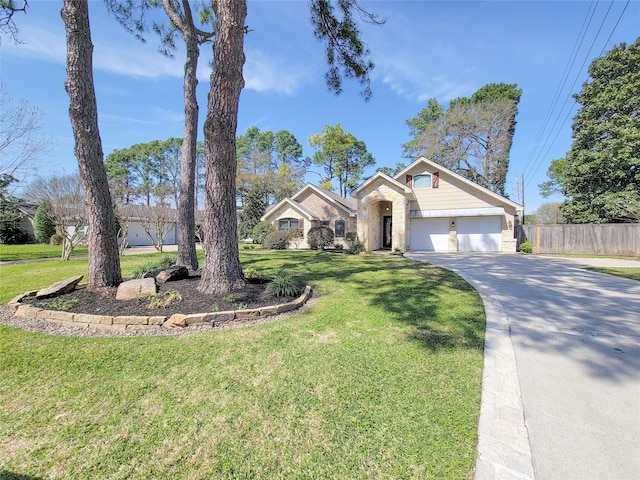 view of front of house with a front lawn, stone siding, fence, concrete driveway, and an attached garage