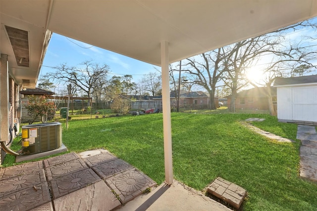 view of yard with a patio, cooling unit, a shed, a fenced backyard, and an outdoor structure