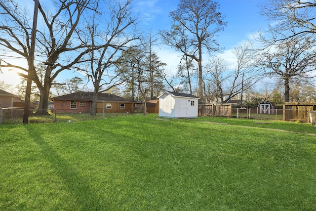 view of yard featuring a fenced backyard, a shed, and an outdoor structure