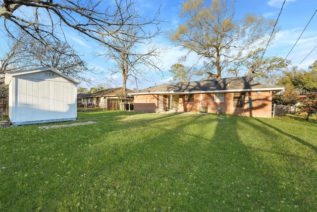 view of yard with an outbuilding, a shed, and fence
