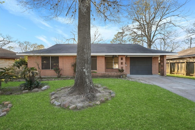 view of front of home featuring a front yard, fence, an attached garage, concrete driveway, and brick siding