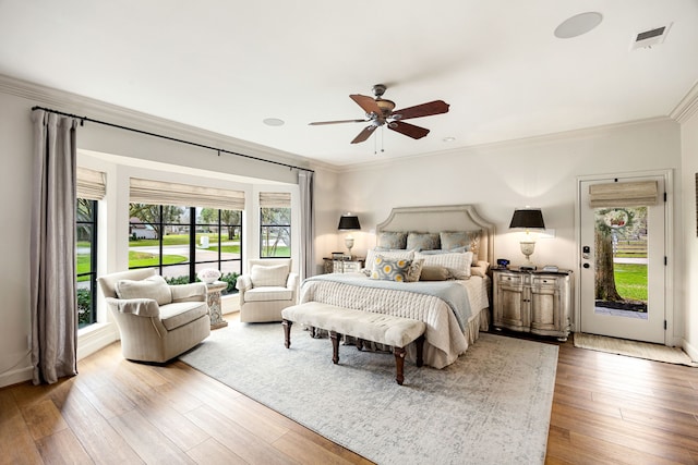 bedroom featuring visible vents, ornamental molding, access to outside, wood finished floors, and ceiling fan