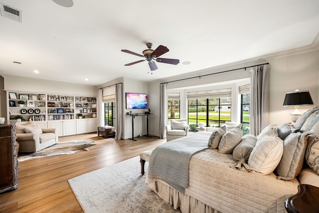 bedroom featuring visible vents, crown molding, light wood-style floors, and access to outside